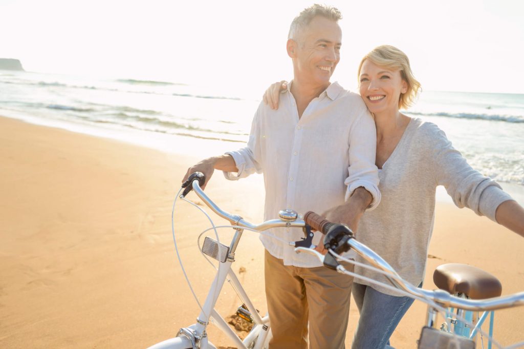 Couple riding bikes on the beach Couple riding bikes on the beach